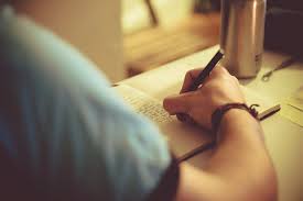 Man Writing in a Notebook