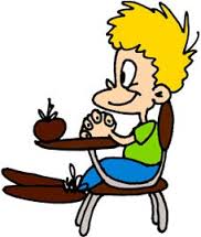 Boy at desk with apple