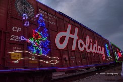 Lynn's Picture Prompt at twilight with neon, the word Holiday, a blue Christmas tree and an elf.
